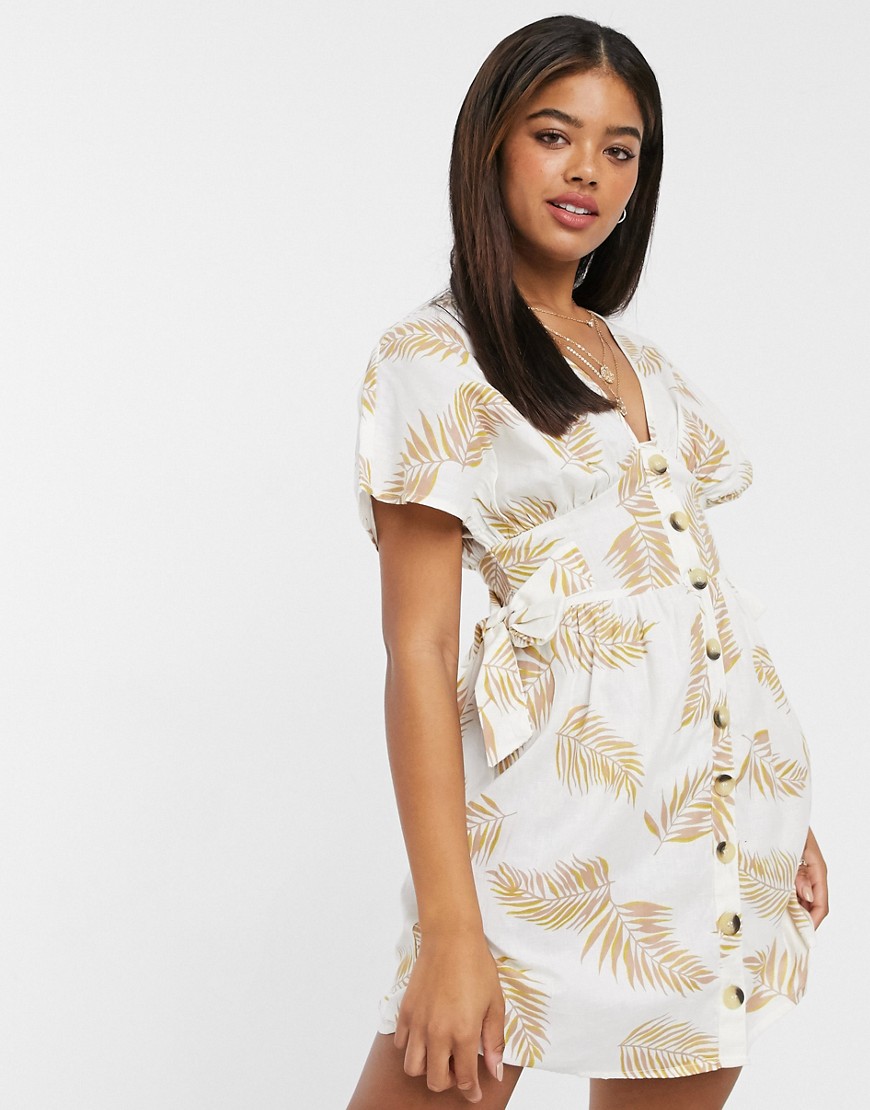 Anmol plażowa sukienka mini zapinana na guzikiz nadrukiem w liście beżowa 40 Anmol-plazowa-sukienka-mini-zapinana-na-guzikiz-nadrukiem-w-liscie-bezowa-40